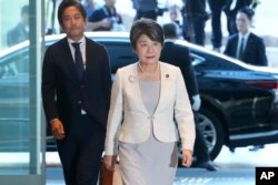 Newly appointed Foreign Minister Yoko Kamikawa, center, arrives at the prime minister's office in Tokyo, Sept.13, 2023.