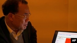 第一个发表新冠病毒序列的中国科学家张永振在他的笔记本电脑上观看演示文稿。（资料照片：2020年12月13日）