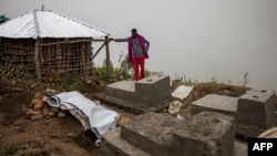 A man mourns the death of a family member at a cemetery close to the scene of a landslide in Kencho Shacha Gozdi on July 26, 2024.