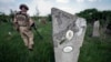 A Ukrainian sapper demines the cemetery on the site of heavy battles with Russian troops in the village of Krasnopillya, Donetsk region, Ukraine, May 2, 2024. (Iryna Rybakova via AP)