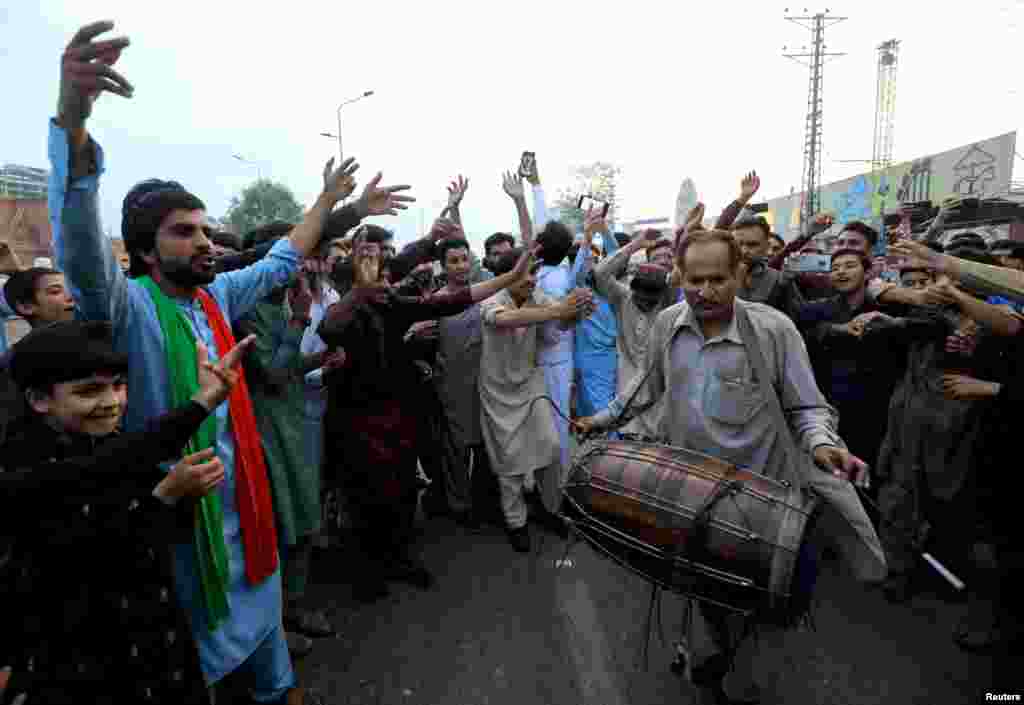 Supporters of Pakistan's former Prime Minister Imran Khan dance as they celebrate after the Supreme Court, according to Khan's lawyer, ruled that Khan's arrest was illegal, in Peshawar, Pakistan.