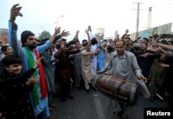 Supporters of Pakistan's former Prime Minister Imran Khan dance as they celebrate after the Supreme Court, according to Khan's lawyer, ruled that Khan's arrest was illegal, in Peshawar, Pakistan.