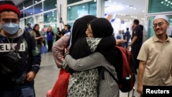 Malaysian national, evacuated from deadly violence in Bangladesh, is greeted by family members, as she arrives at Kuala Lumpur International Airport Terminal 2 in Sepang, July 23, 2024.