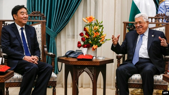 FILE - Zhai Jun, Special Envoy of the Chinese Government on the Middle East Issue, meets with Palestinian president Mahmud Abbas at his office in the West Bank city of Ramallah on Dec. 7, 2019.