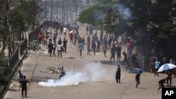 Students clash with riot police during a protest against a quota system for government jobs in Dhaka, Bangladesh, July 18, 2024.