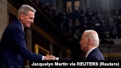 FILE: President Joe Biden shakes hands with House Speaker Kevin McCarthy of Calif., after the State of the Union address to a joint session of Congress at the Capitol, on Tues. Feb. 7, 2023, in Washington