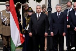 Hungary Prime Minister Viktor Orban, center, waits for the arrival of Pope Francis in the square of "Sándor" Palace in Budapest, April 28, 2023.