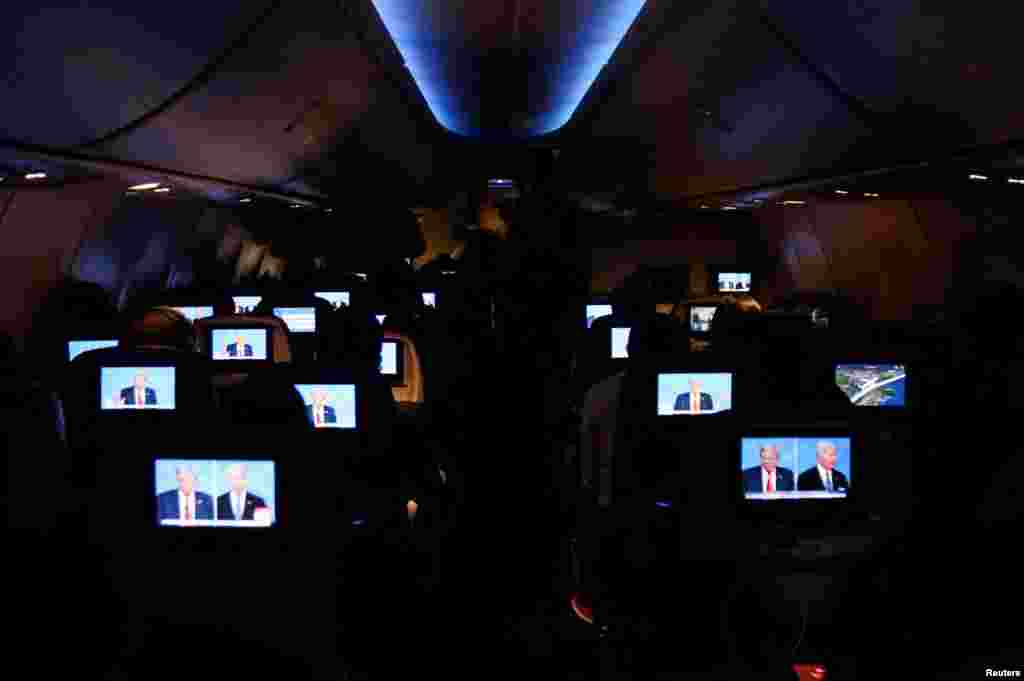 People watch the U.S. presidential debate aboard a Delta Airlines flight to Miami, Florida, on June 27, 2024. REUTERS/Maria Alejandra Cardona