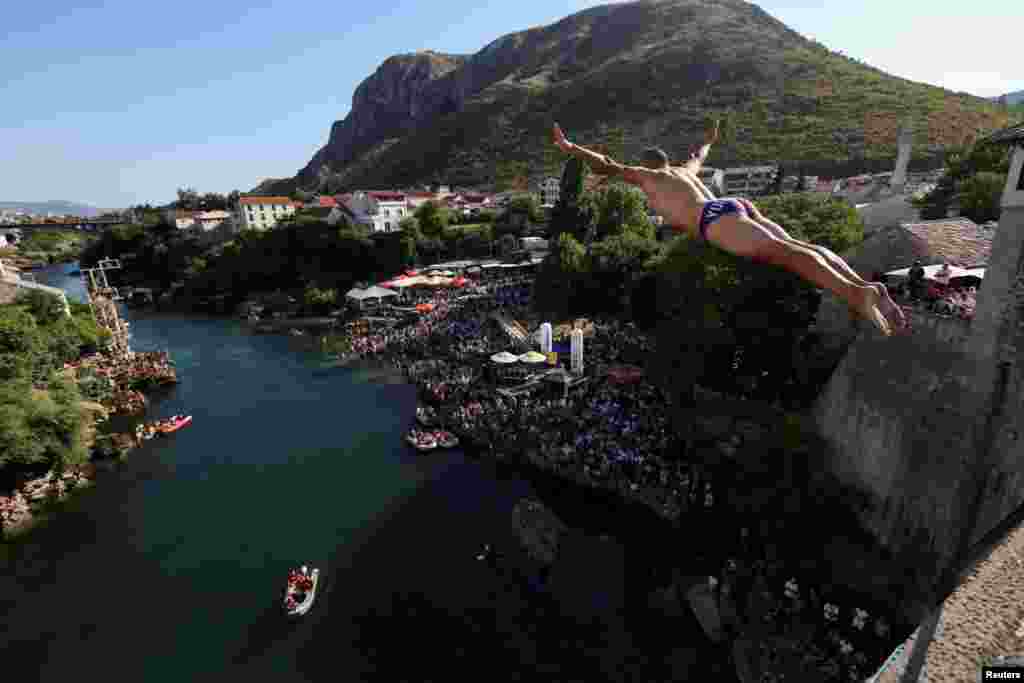 A high diver jumps from the arch of the Old Bridge during 458th edition of the traditional diving competition in Mostar, Bosnia and Herzegovina, July 28, 2024. 