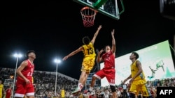 This photo taken July 29, 2023, shows basketball players competing during a knockout game of the grassroots basketball competition CunBA in Taipan village, Taijiang county, in southwestern China's Guizhou province.