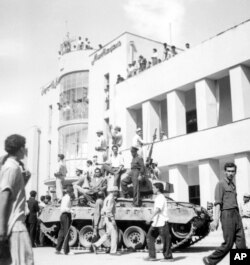 FILE - A royalist tank moves into the courtyard of Tehran Radio a few minutes after pro-shah troops occupied the area during the coup that ousted Mohammad Mosaddegh and his government in Iran on Aug. 19, 1953.