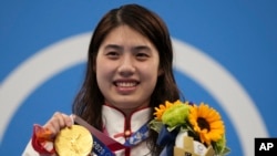 FILE - Zhang Yufei of China poses with her gold medal after winning the women's 200-meter butterfly final at the 2020 Summer Olympics, on July 29, 2021, in Tokyo, Japan. 
