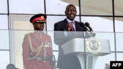 Kenyan President William Ruto (R) delivers his speech during the celebrations of Kenya's 60th Independence Day, also known as Jamhuri Day, at the Uhuru Gardens in Nairobi on December 12, 2023.