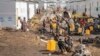 People displaced by the ongoing fighting between Congolese forces and FILE - M23 rebels gather in a camp on the outskirts of Goma, Democratic Republic of Congo, March 13, 2024, 