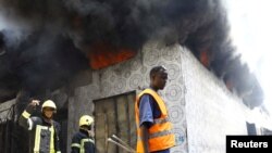 FILE — Firefighters arrive to extinguish a fire at the Baraka market after an explosion in the shopping area in Mogadishu, March 10, 2024. 