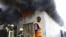 FILE — Firefighters arrive to extinguish a fire at the Baraka market after an explosion in the shopping area in Mogadishu, March 10, 2024. 