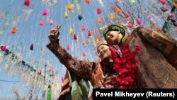 Participants take a selfie during a Nowruz festival in Kazakhstan.