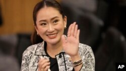 Leader of Pheu Thai Party, Paetongtarn Shinawatra, daughter of Thailand's former Prime Minister Thaksin Shinawatra, waves before press conference in Bangkok, Thailand, Aug. 15, 2024.