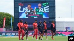 Team United States cricketers walk in the field before an ICC Men's T20 World Cup cricket match between the US and Ireland at the Central Broward Regional Park Stadium in Lauderhill, Fla., June 14, 2024.