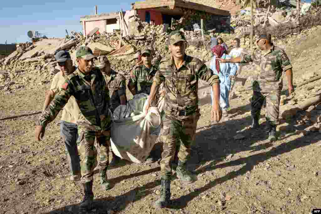 Moroccan Royal Armed Forces remove a body from a house destroyed in an earthquake in the mountain village of Tafeghaghte, southwest of the city of Marrakesh, Morocco, on Sept. 9, 2023. 