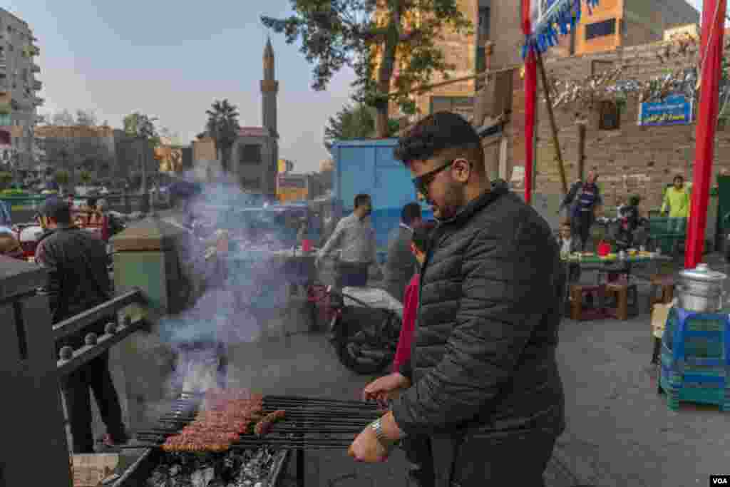 Youssef, whose business-owning family has put on charity iftars for 36 years, is seen in Cairo, March 26, 2023. &quot;We usually serve pieces of meat, but this year, we&#39;re only offering rissoles [roasted meat with herbs and beans] so more people can eat,&quot; Youssef says. (Hamada Elrasam/VOA)&nbsp;