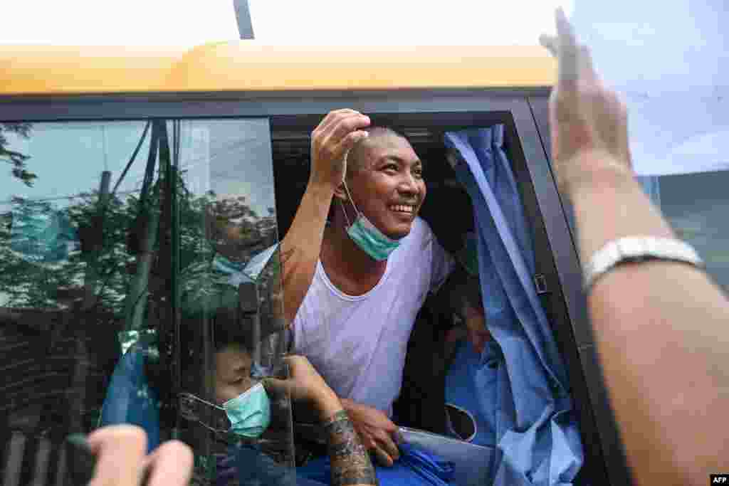A prisoner who is being released smiles from a bus outside the Insein prison in Yangon. Myanmar's junta pardoned 2,153 prisoners jailed under a law that criminalizes encouraging dissent against the military. 