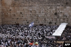 Jewish men take part in the Cohanim prayer (priest's blessing) during the Passover holiday at the Western Wall in the Old City of Jerusalem, Apr. 9, 2023.