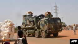 A French Army military vehicle belonging to a convoy of French troops is seen crossing the Lazaret district in Niamey, Niger, Oct. 10, 2023.