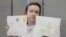 American-Russian journalist for Radio Free Europe/Radio Liberty (RFE/RL) Alsu Kurmasheva, holds drawings by her supporters as she attends a court hearing in Kazan, Russia, May 31, 2024. 