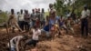 Residents and volunteers dig in the mud in search for bodies at the scene of a landslide in the Kencho Shacha Gozdi district of southern Ethiopia, July 25, 2024.