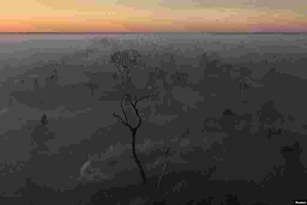 A drone view shows smoke from a fire rising into the air as trees burn amongst vegetation in the Pantanal, the world's largest wetland, in Corumba, Mato Grosso do Sul state, Brazil.