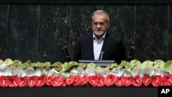 Newly-elected President Masoud Pezeshkian delivers a speech after taking his oath in a ceremony at the parliament in Tehran, Iran, July 30, 2024.