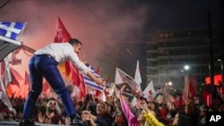 Leader of the main opposition Syriza party, Alexis Tsipras, shakes hands with his supporters during a pre-election rally, in Athens, on Thursday, May 18, 2023.