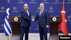 Turkish Foreign Minister Hakan Fidan, right, shakes hands with his Greek counterpart, Giorgos Gerapetritis, during their press conference in Ankara, Turkey, Sept. 5, 2023.