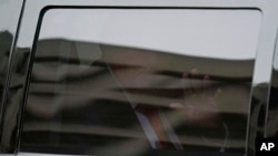 Former President Donald Trump waves from his motorcade as he leaves the E. Barrett Prettyman U.S. Federal Courthouse, Thursday, Aug. 3, 2023, in Washington.