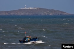 FILE - A Chinese fishing boat sails across the Taiwan Strait near the Taiwan-controlled Niushan Island, off Pingtan Island, Fujian province, China, April 9, 2023.