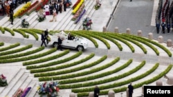 Pope Francis sits in a vehicle on the day of the Easter Mass at St. Peter&#39;s Square at the Vatican.