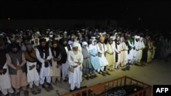 People offer funeral prayers for a blast victim in Mastung district on Sept. 29, 2023 following a suicide bomb attack targeting a procession marking the birthday of Islam's Prophet Muhammad.