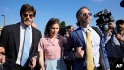 Amanda Knox arrives flanked by her husband Christopher Robinson, right, and her lawyer Luca Luparia Donati at the Florence courtroom in Florence, Italy, June 5, 2024.