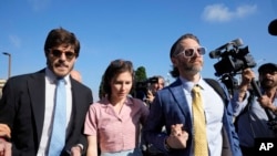 FILE - Amanda Knox arrives with her husband Christopher Robinson, right, and her lawyer Luca Luparia Donati at the Florence courtroom in Florence, Italy, June 5, 2024. 