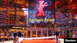 Workers lay the red carpet for the upcoming Berlin International Film Festival in Berlin, Germany, Feb. 14, 2023.