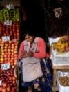 FILE - A vendor waits for customers at her produce stand, a day after Army troops stormed the government palace in what President Luis Arce called a coup attempt, in La Paz, Bolivia, June 27, 2024. 