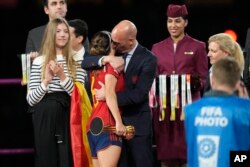 President of Spain's soccer federation, Luis Rubiales, right, hugs Spain's Aitana Bonmati on the podium following Spain's win in the final of Women's World Cup soccer against England at Stadium Australia in Sydney, Australia, Aug. 20, 2023.