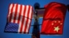 FILE - The flags of the United States and China fly from a lamppost in the Chinatown neighborhood of Boston, Massachusetts, Nov. 1, 2021. The United States, Aug. 8, 2024, banned imports from five more Chinese companies over alleged human rights abuses involving the Uyghurs.