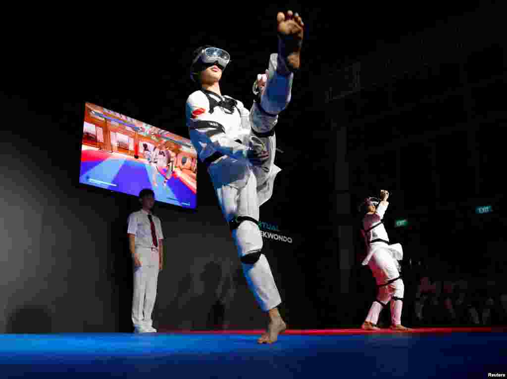 Nigel Tan of Singapore fights against compatriot Alexander Tang in their virtual taekwondo qualifying match at the Olympic Esports Week in Singapore.