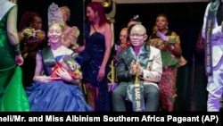 Winners of the Mr. and Miss Albinism Southern Africa Pageant, Andreia Solange Sicato Muhitu, left, and Ntandoyenkosi Mnkandla, at the Harare International Conference Centre, Oct. 14, 2023.