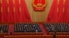 FILE - Delegates applaud as Chinese President Xi Jinping, left, arrives at the closing ceremony for China's National People's Congress at the Great Hall of the People in Beijing, March 13, 2023. Xi has urged his nation to pursue a role as a global tech power.