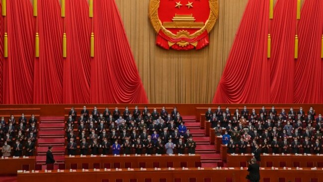 Delegates applaud as Chinese President Xi Jinping, left, arrives at the closing ceremony for China's National People's Congress (NPC) at the Great Hall of the People in Beijing, March 13, 2023.