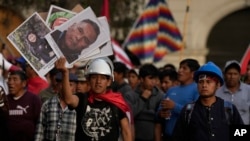 Con carteles con las fotos de las víctimas de la violencia política, los manifestantes marchan contra la presidenta peruana Dina Boluarte en Lima, Perú, el 1 de febrero de 2023.