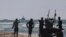 A ship belonging to the Open Arms aid group approaches the shores of Gaza towing a barge with 200 tons of humanitarian aid, March 15, 2024. The ship set sail Tuesday from Cyprus to inaugurate a sea route to get aid into the war-wracked enclave.